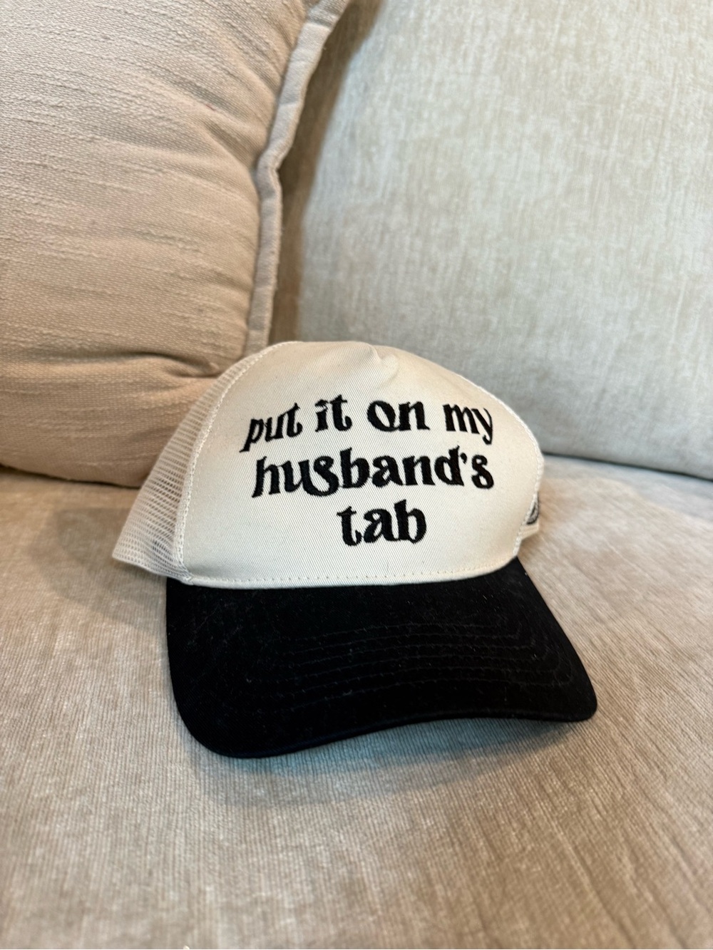 White and Black Trucker Hat with 'put it on my husband's tab' Embroidery